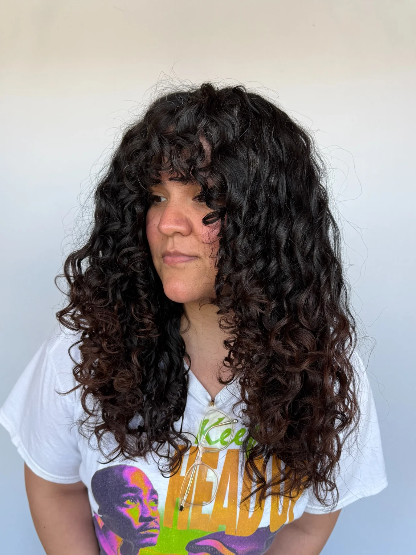 Long dark curls with face-framing shape