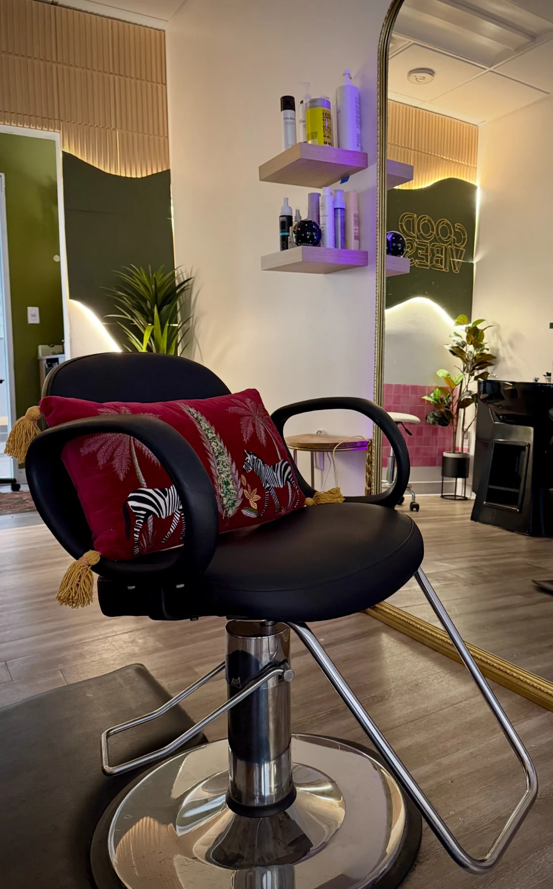 The styling chair and large mirror inside The Afterglow Curl Studio